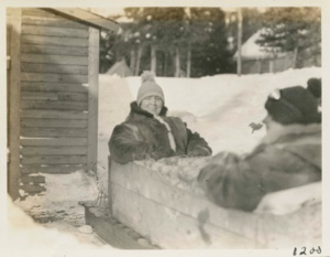 Image: Mrs. Taylor seated in sledge box ready to start for home